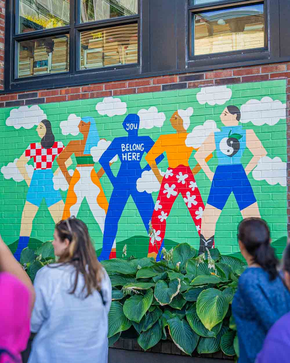 guests looking at a portland street mural
